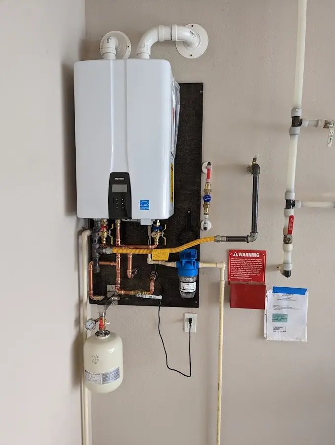 Professional plumber installing copper piping in a Old Forge home